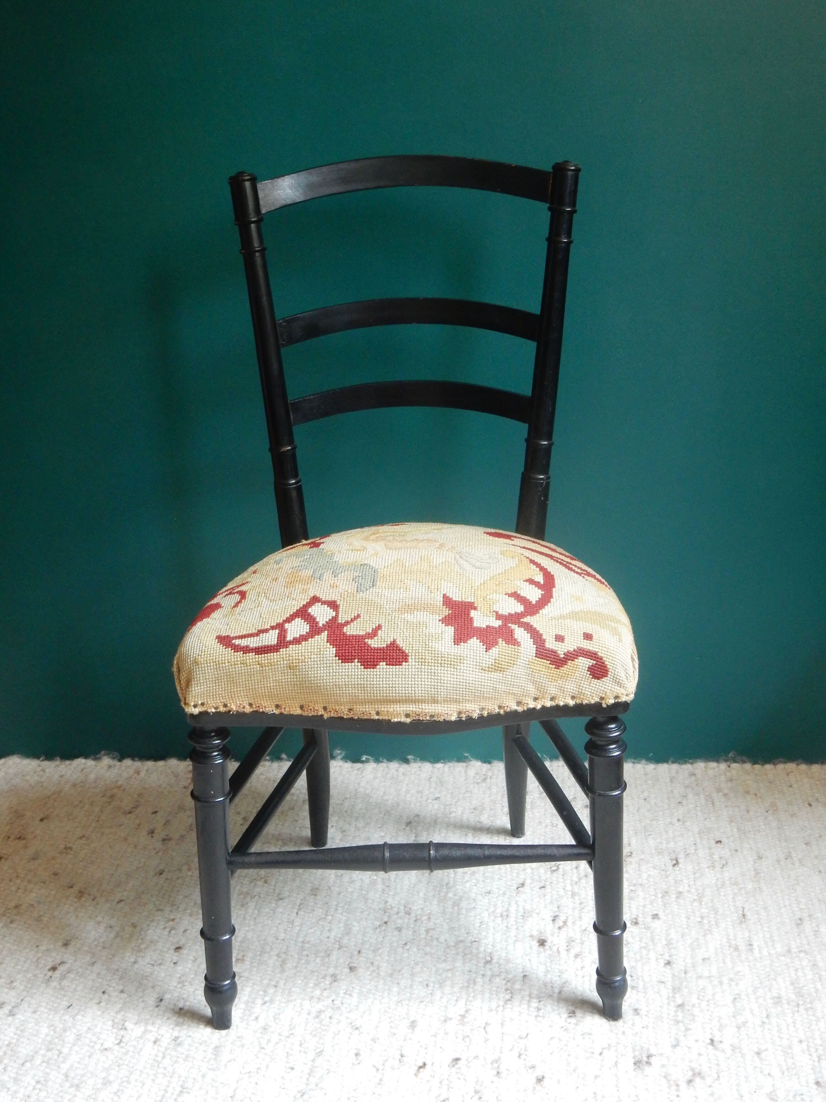 Black Napoleon III chair lined with phoenix