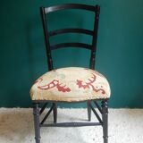 Black Napoleon III chair lined with phoenix