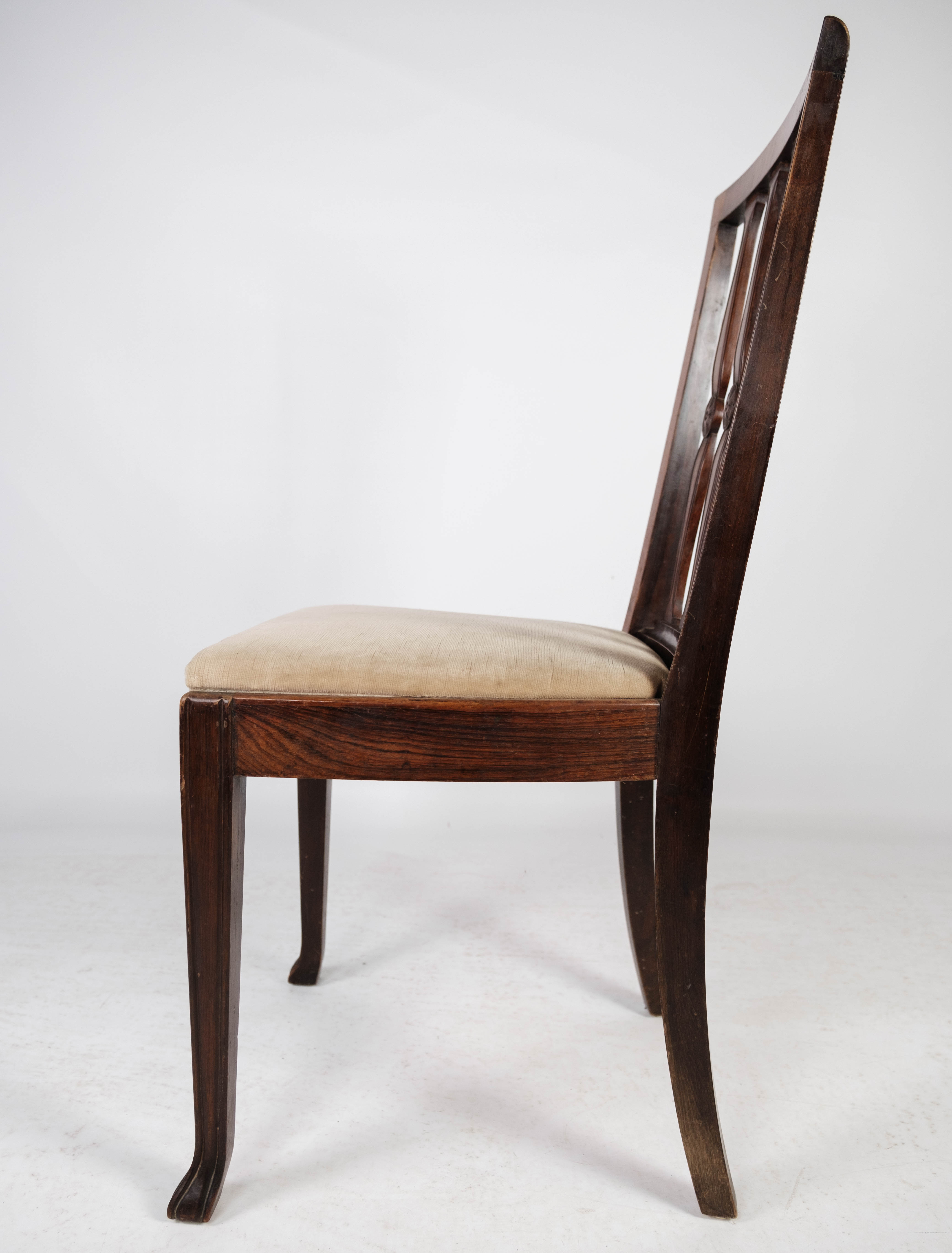 Set of four dining room chairs in rosewood and upholstered with light fabric, 1920s