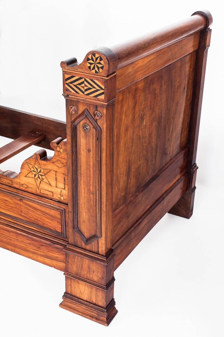 Bed made of solid walnut with marquetry details. France, 1930s.