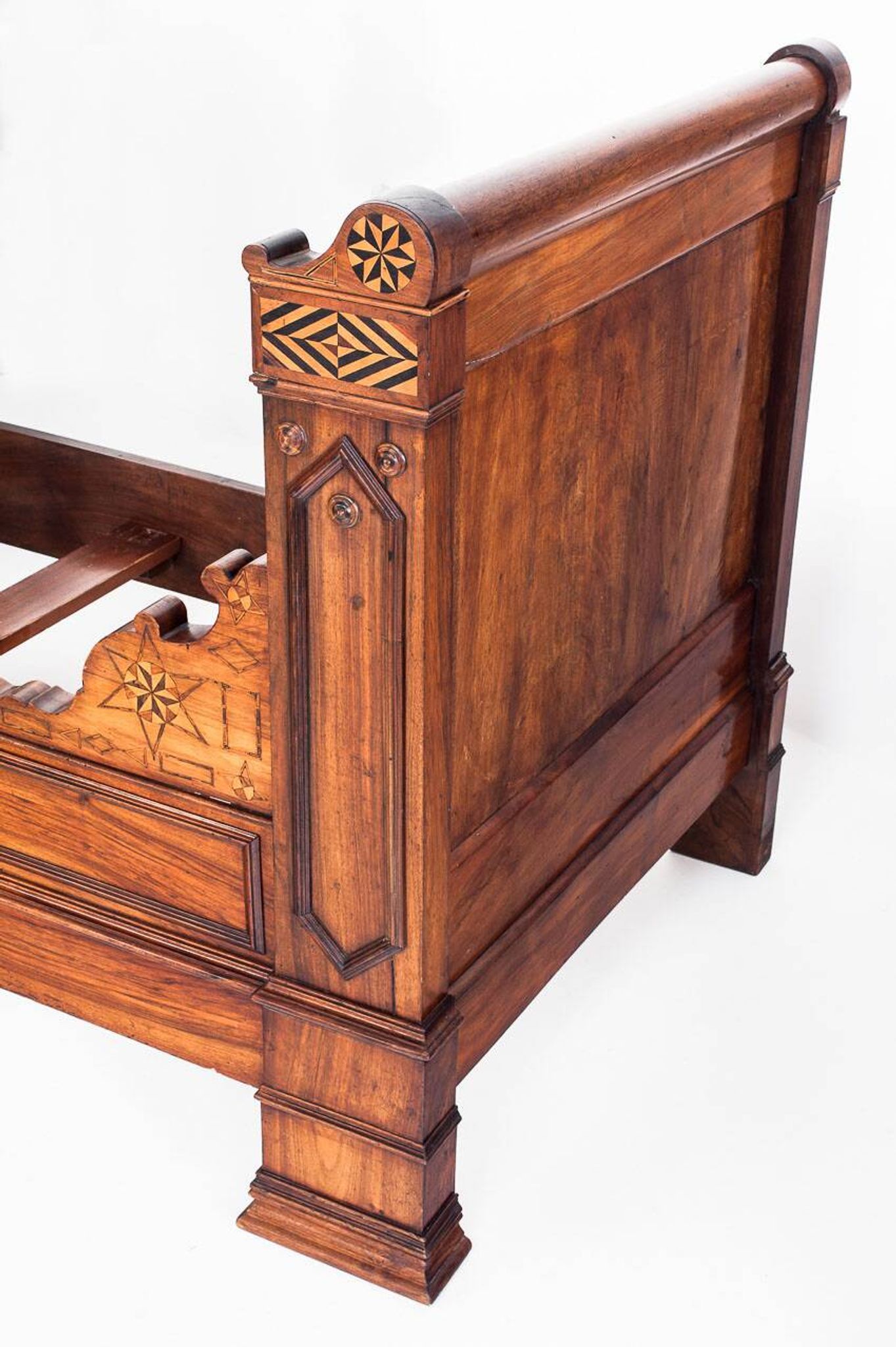 Bed made of solid walnut with marquetry details. France, 1930s.