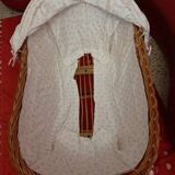 Vintage 1970s wicker cradle on wheels