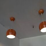 Pair of 70's globes in orange lacquered metal.