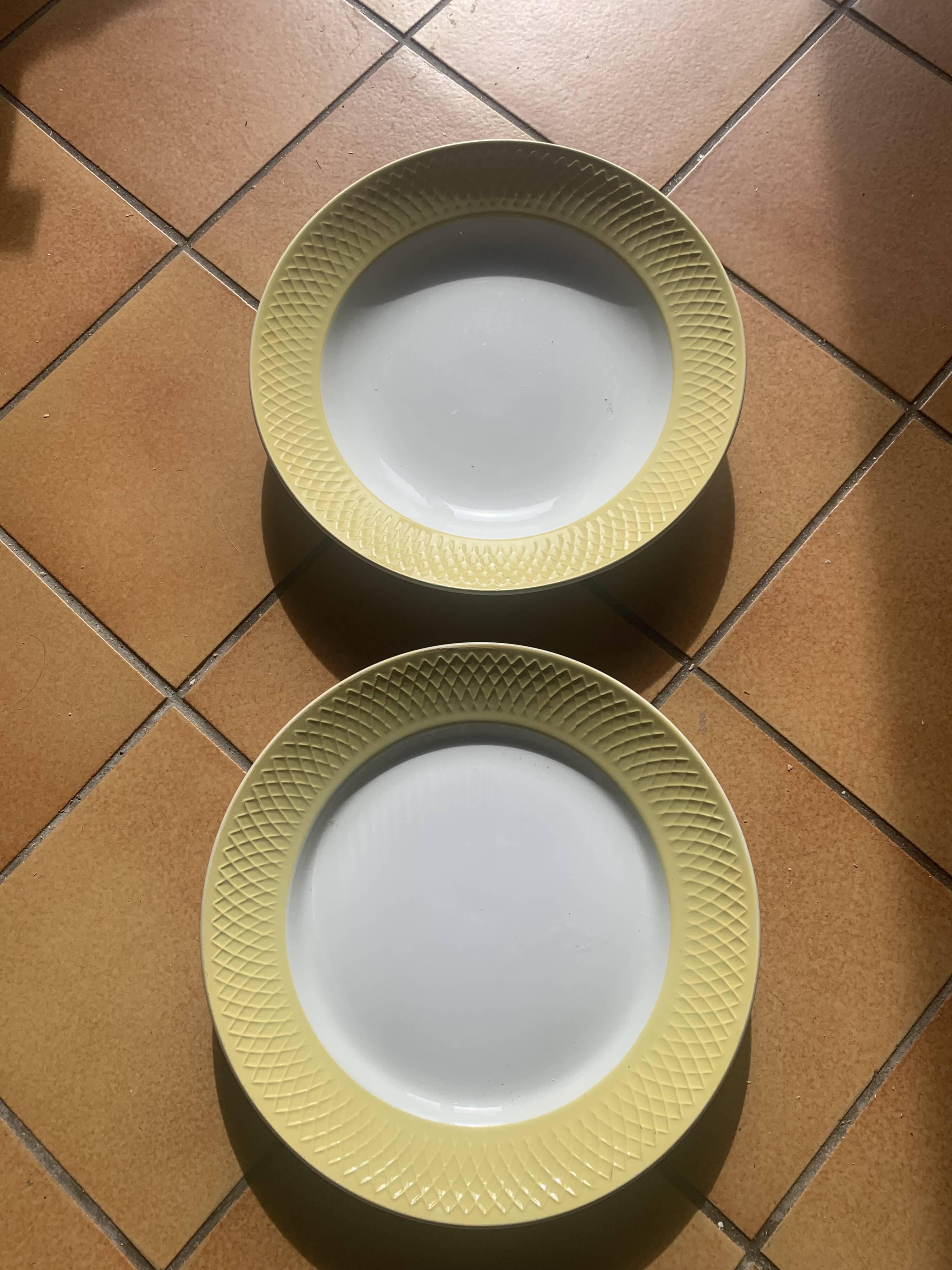 Two earthenware dishes, one hollow and one white cake dish with yellow border