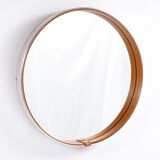 Round mirror covered with leather and chrome, made in France in the 1970s.