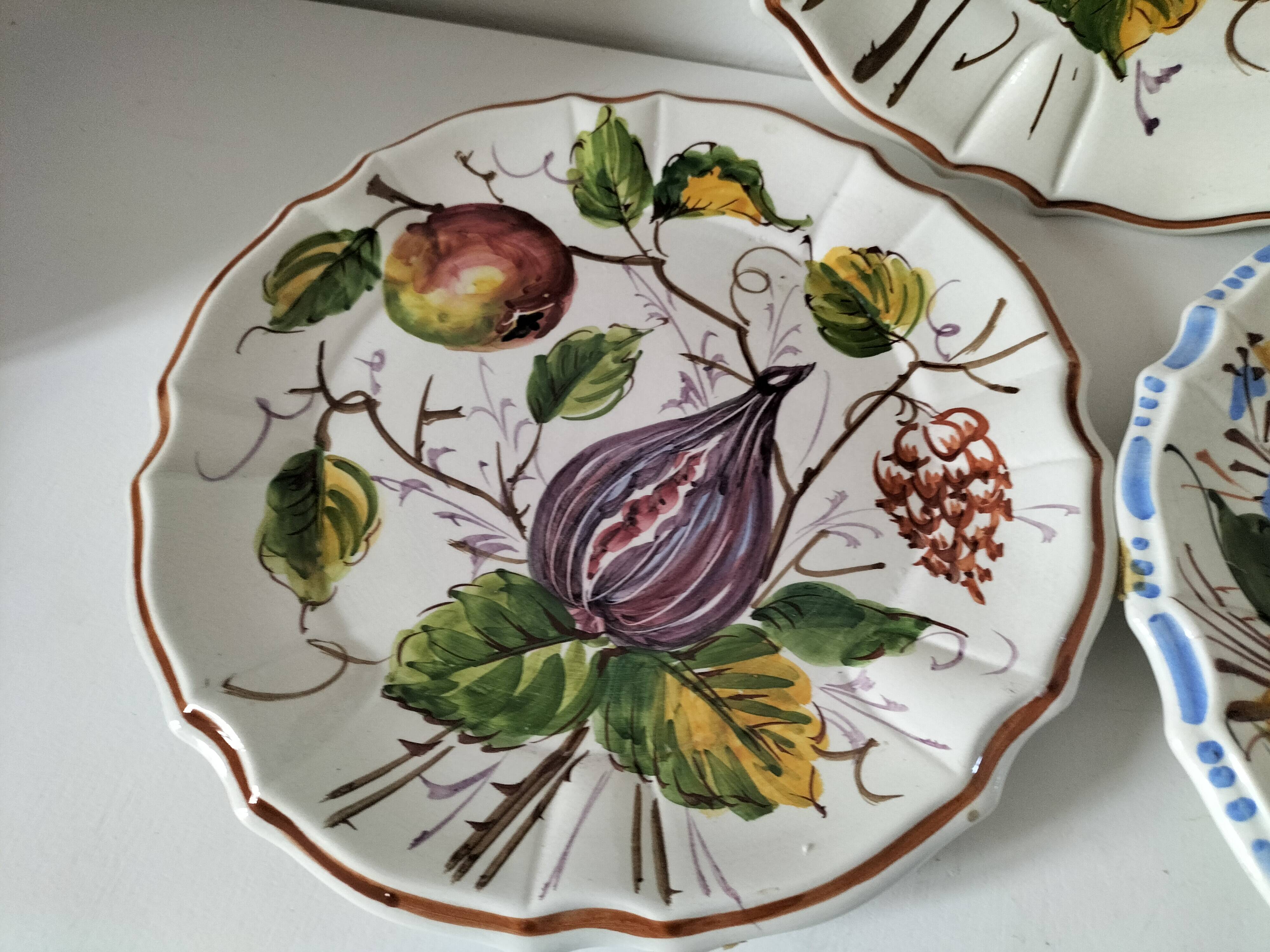 Set of three earthenware plates from Bassano, hand-painted with fruit and flower designs.