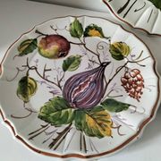 Set of three earthenware plates from Bassano, hand-painted with fruit and flower designs.