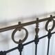 Old bed in black iron and brass