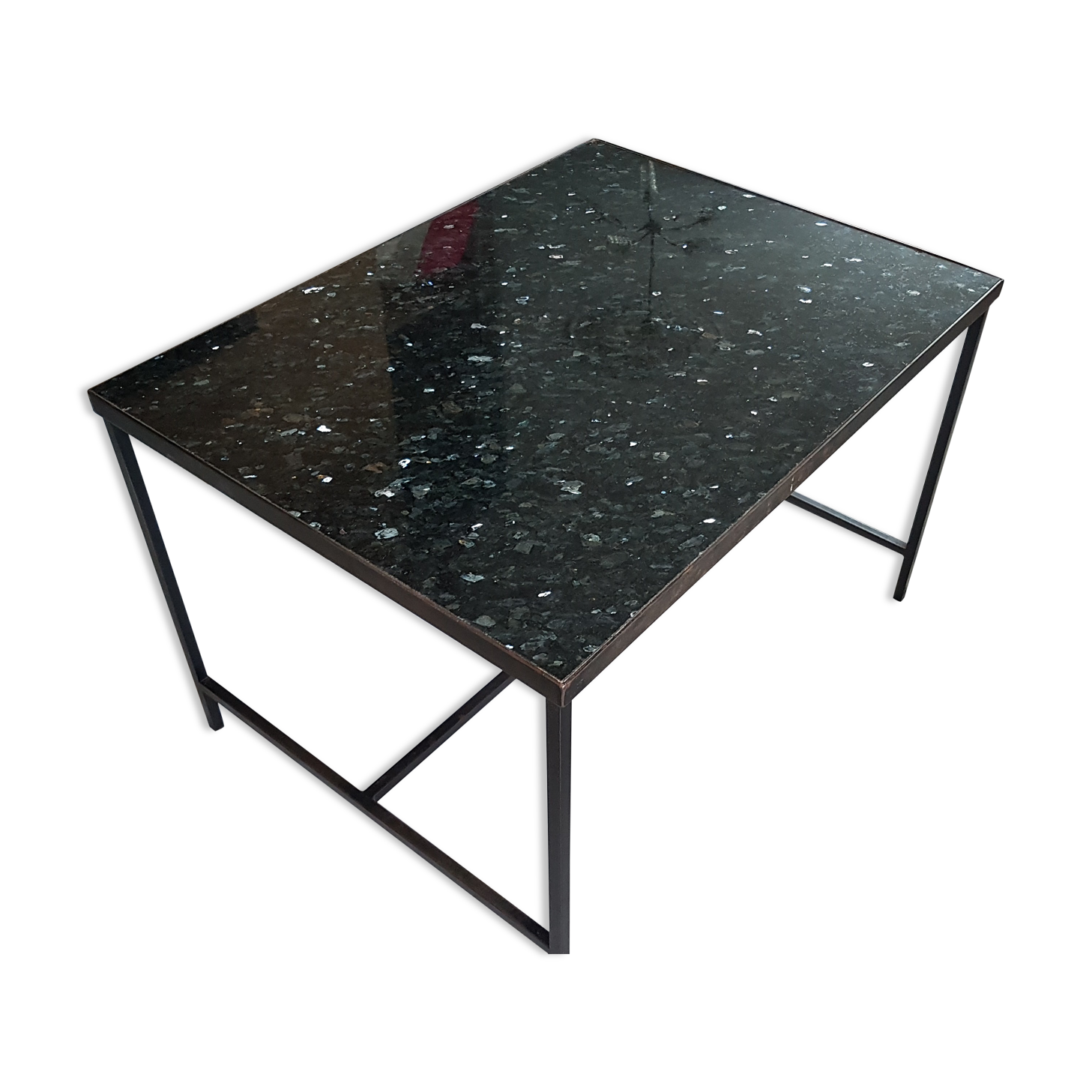 Coffee table with top in silver granite and welded steel base.