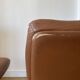 Pair of swivel armchairs in cognac colour.
