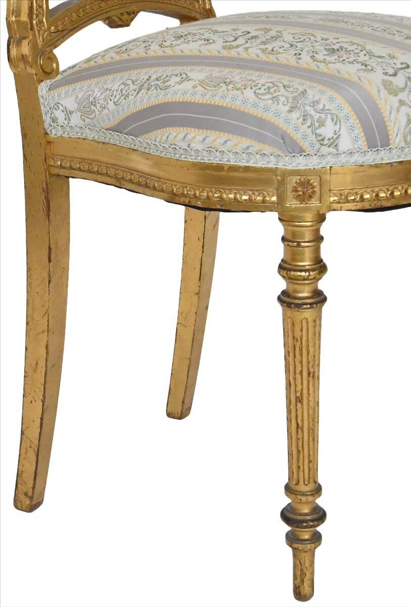 Pair of Louis XVI style chairs in gilded wood.
