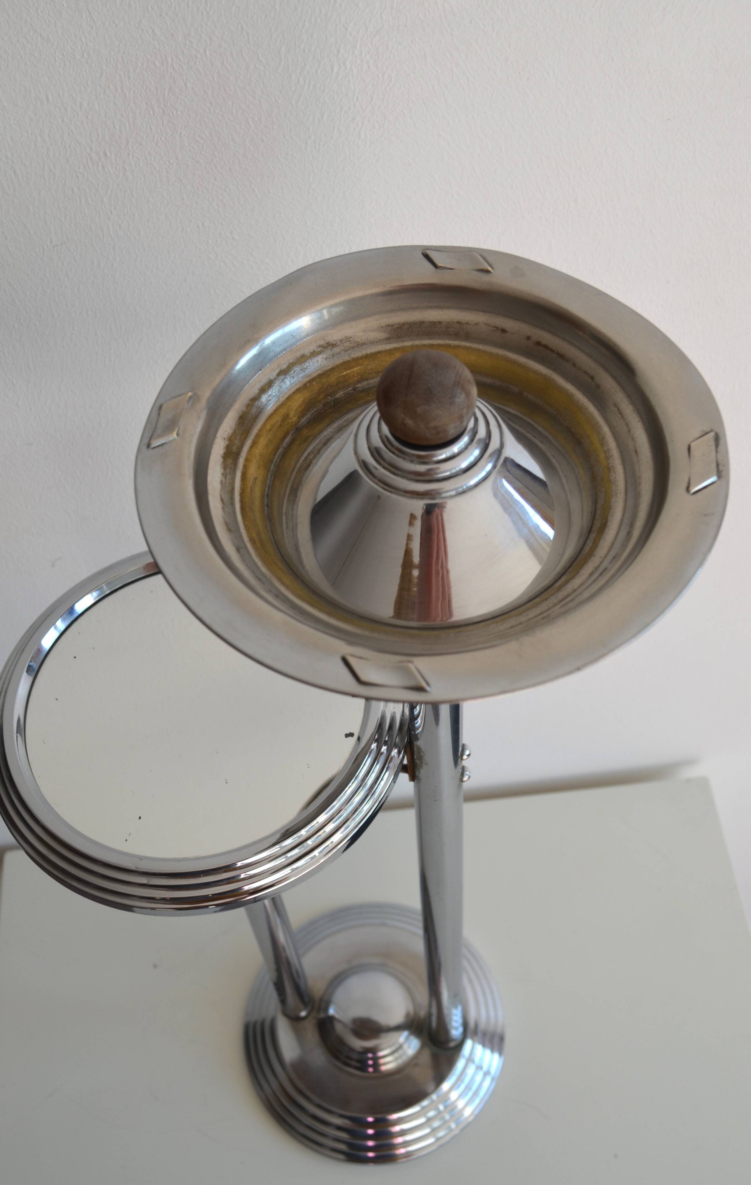 Ashtray and shelf on chrome metal stand.