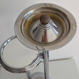 Ashtray and shelf on chrome metal stand.