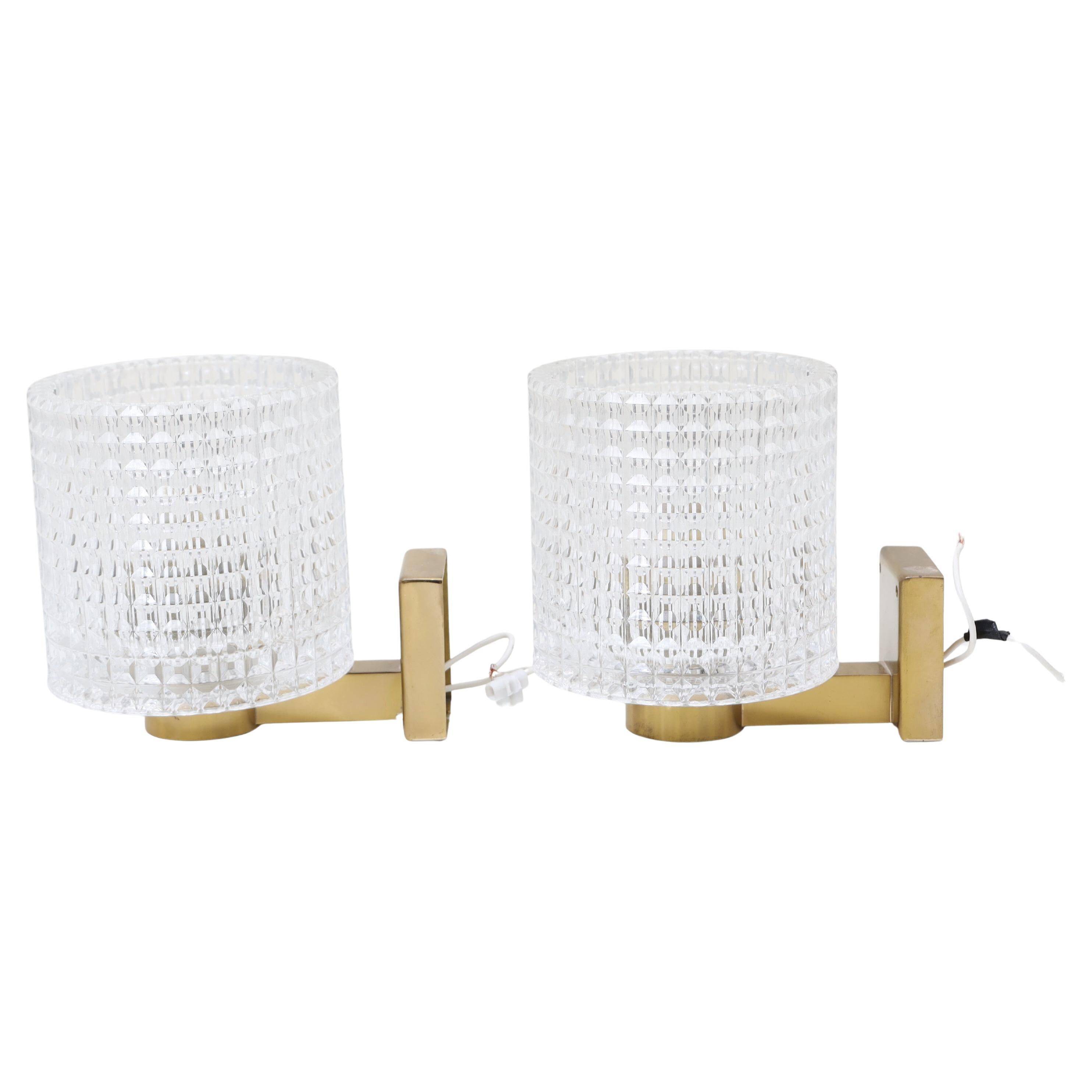 Carl Fagerlund for Orrefors Pair of wall lights in brass and glass Sweden 1960