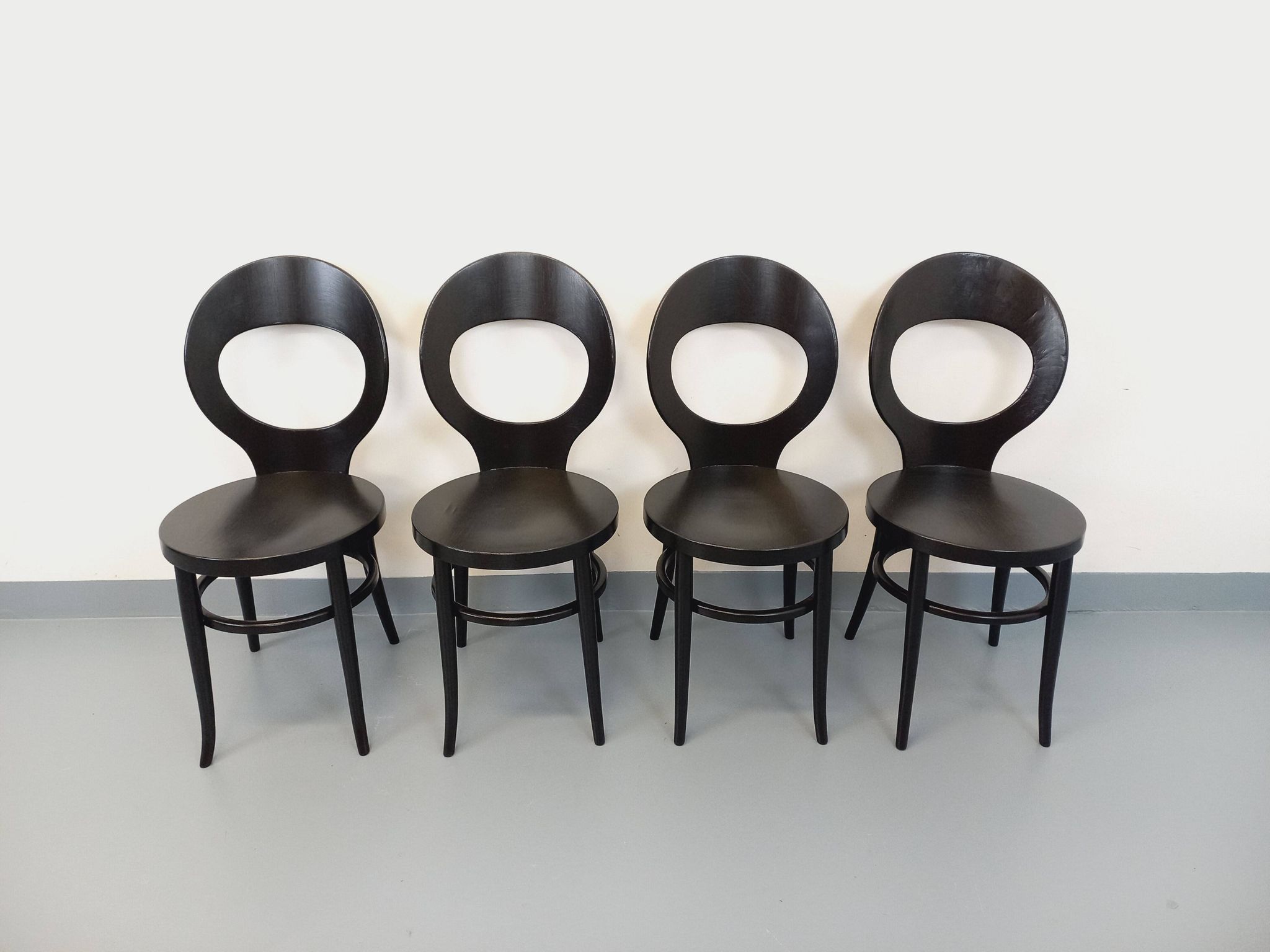 Set of 4 vintage Mouette chairs by Baumann in black wood from the 1960s.