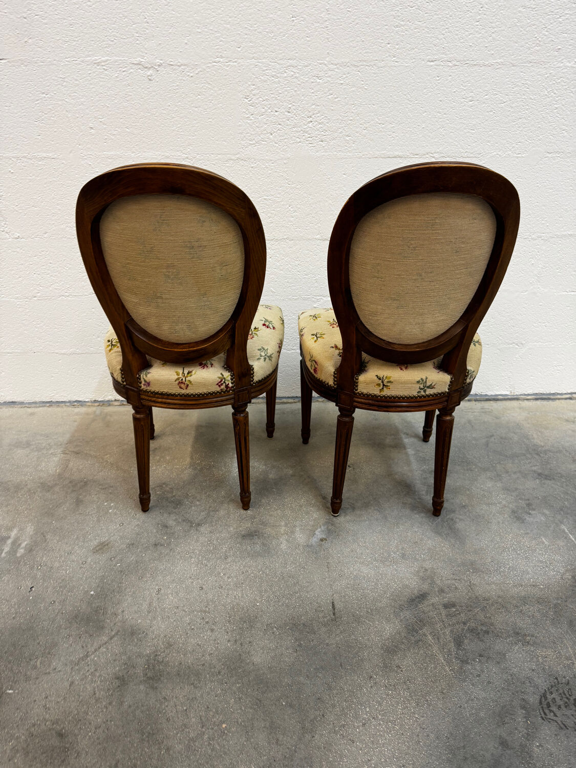 Pair of Louis XVI medallion chairs with canvas.