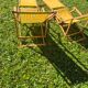 2 vintage Chilean deck chairs made of wood and yellow fabric printed with sailboats, with footrests.