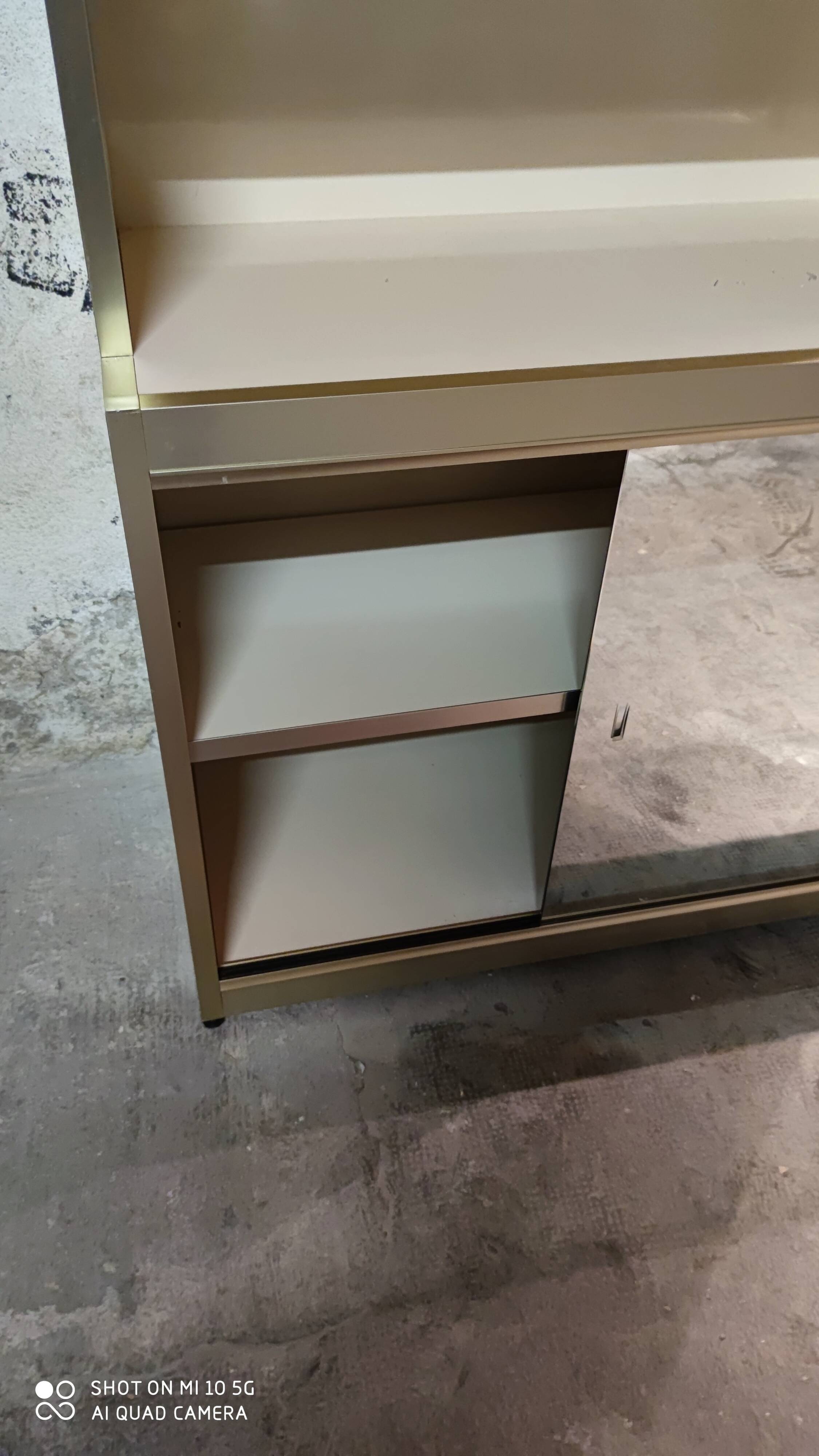 Ivory-colored and matte gold anodized aluminum display bookcase