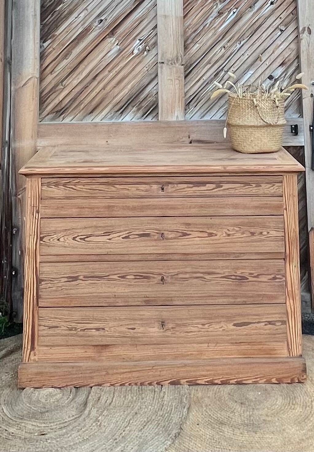 Large antique chest of drawers in raw solid wood.