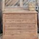 Large antique chest of drawers in raw solid wood.