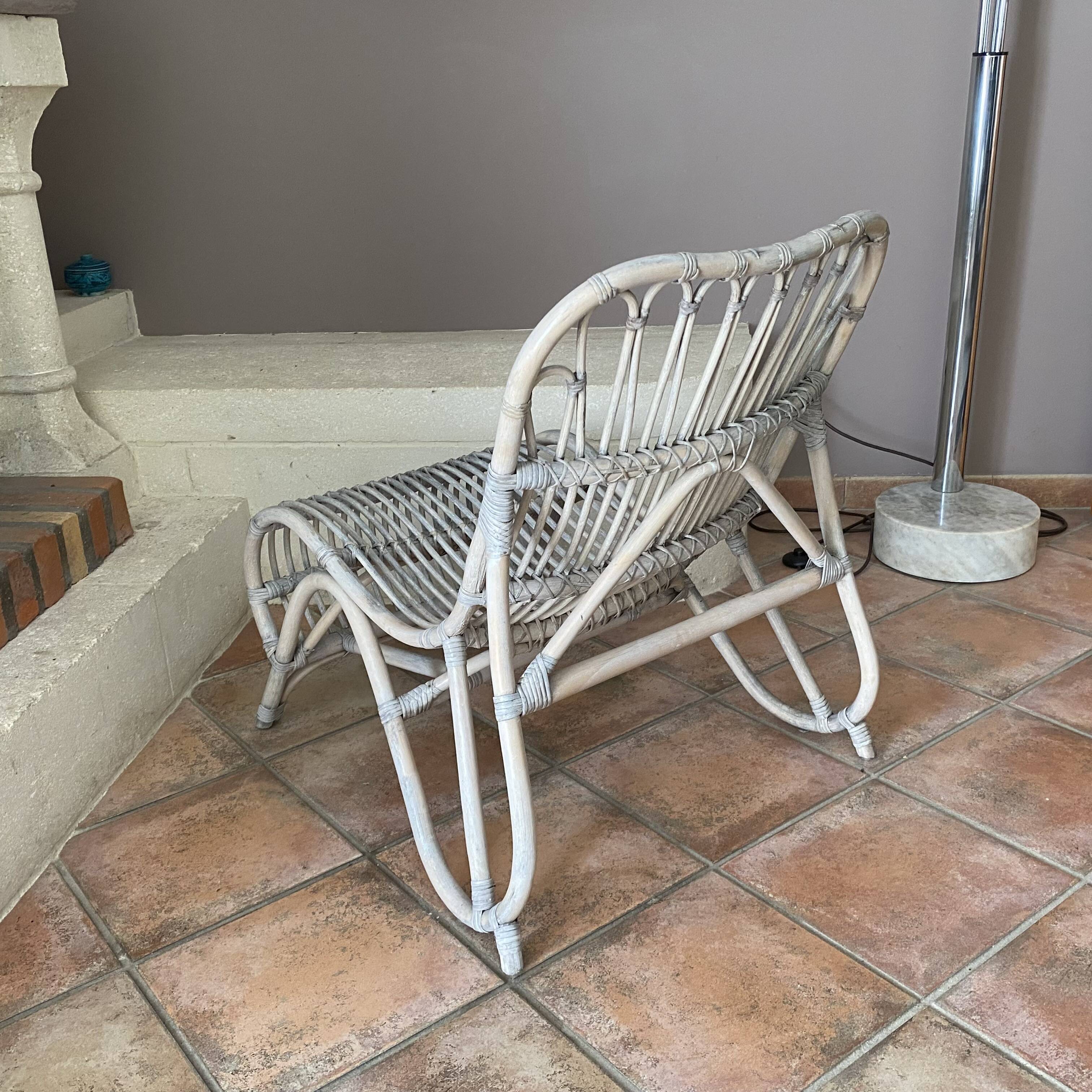 Vintage arched rattan armchair. 1970s.