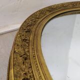 Golden oval mirror