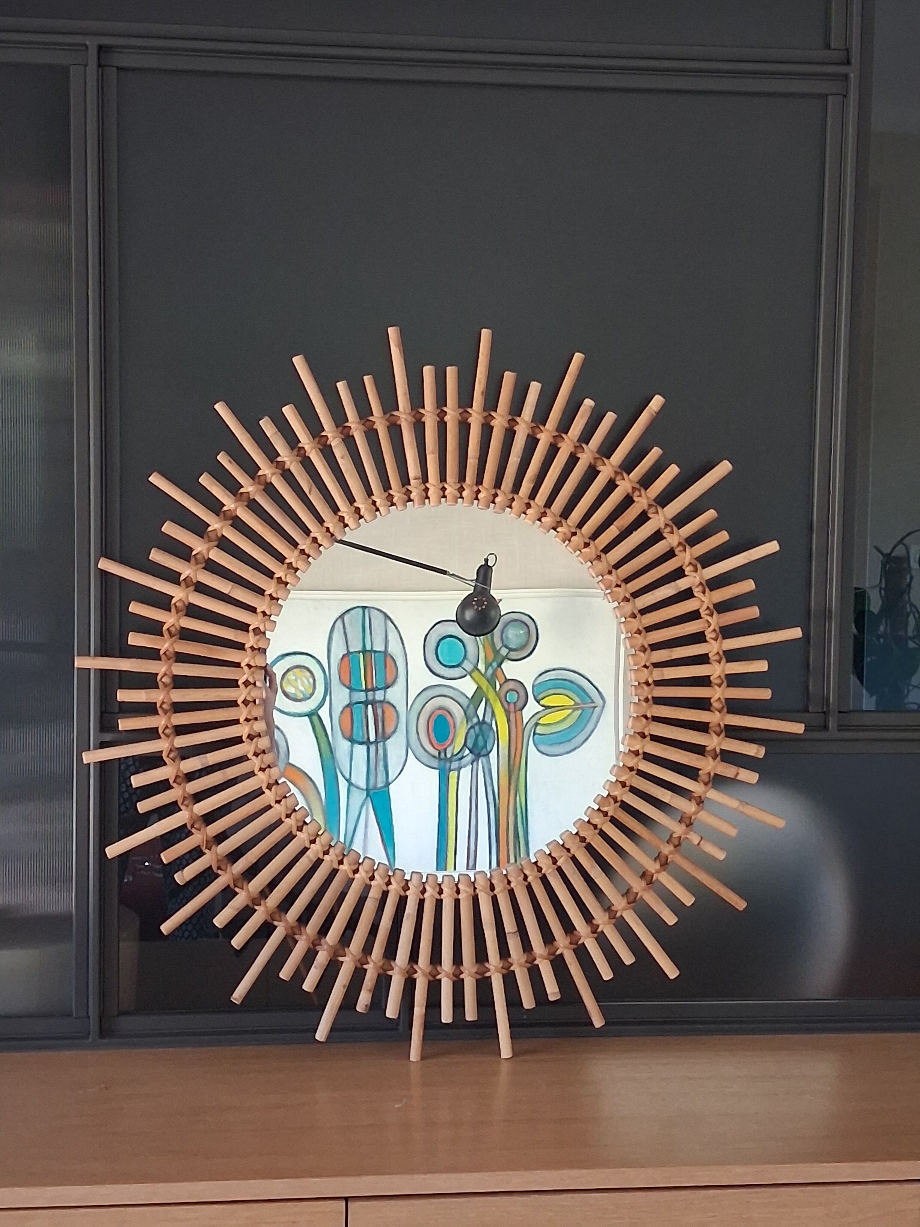 Very large sun mirror in rattan.