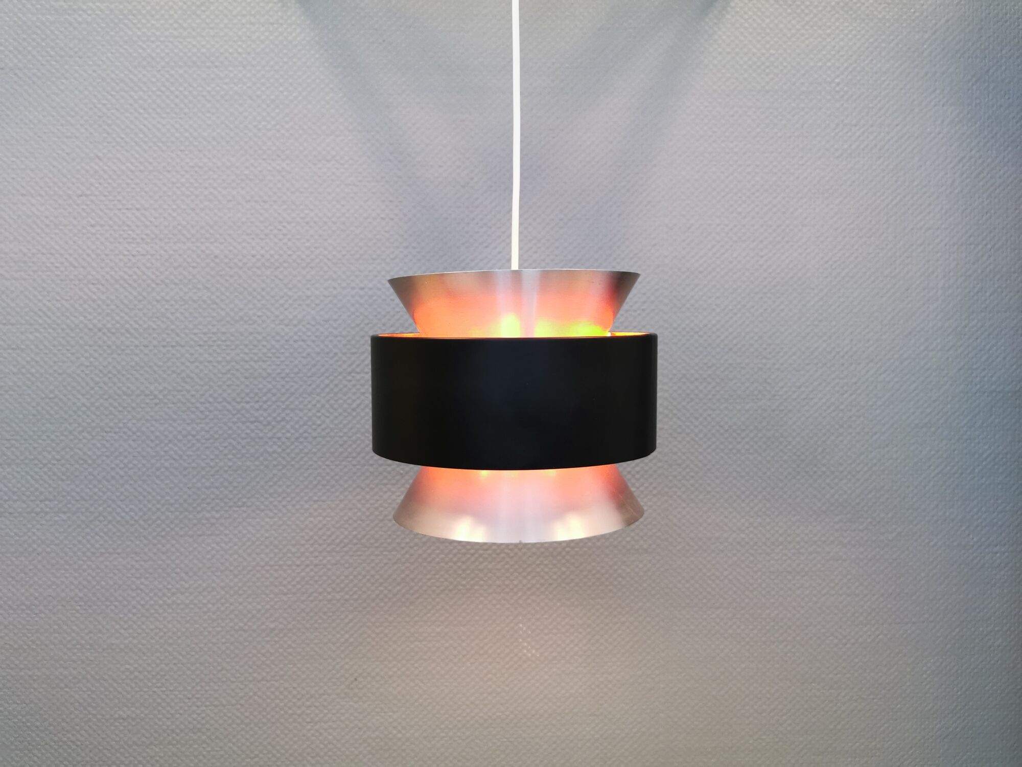 Hanging lamp,  of silver coloured aluminium with black "ring" and orange inner contrast lacquer.
