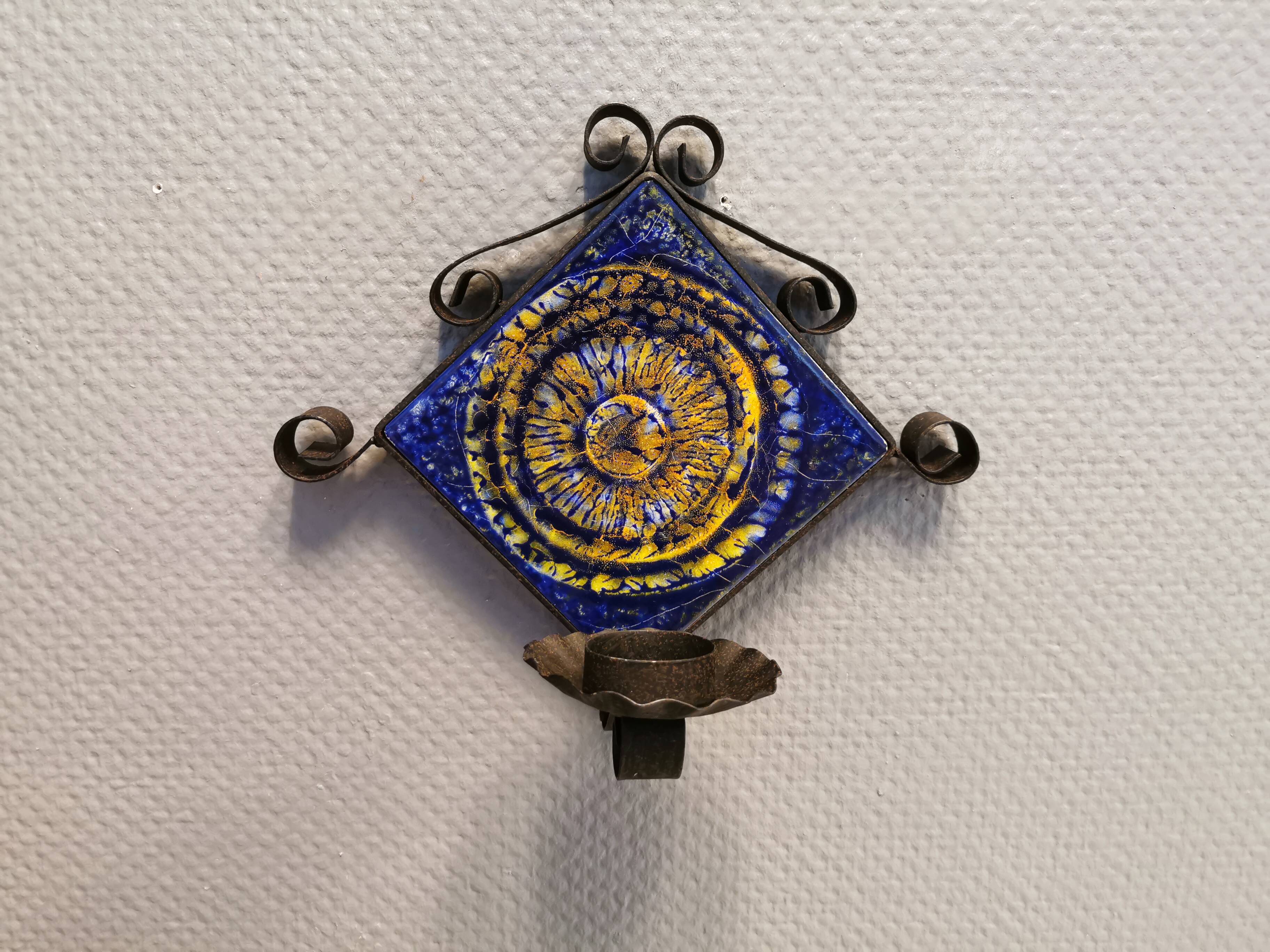 Wall-mounted candle holder in cast iron and ceramic. Estimated Danish and from the 70s.