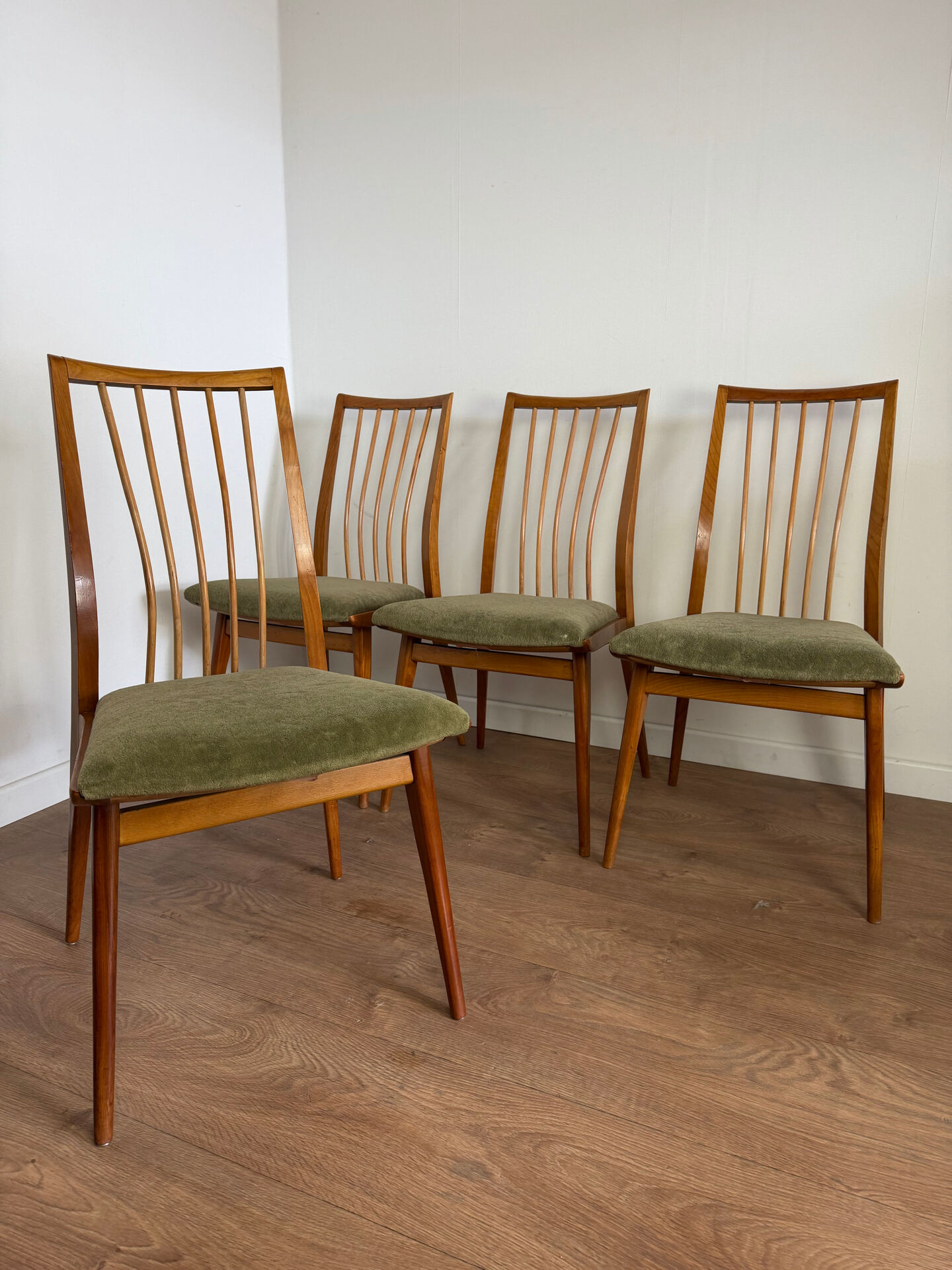 Scandinavian chairs with green velvet upholstery.