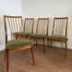 Scandinavian chairs with green velvet upholstery.