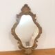 Bakelite scrolled mirror with rocaille pediment