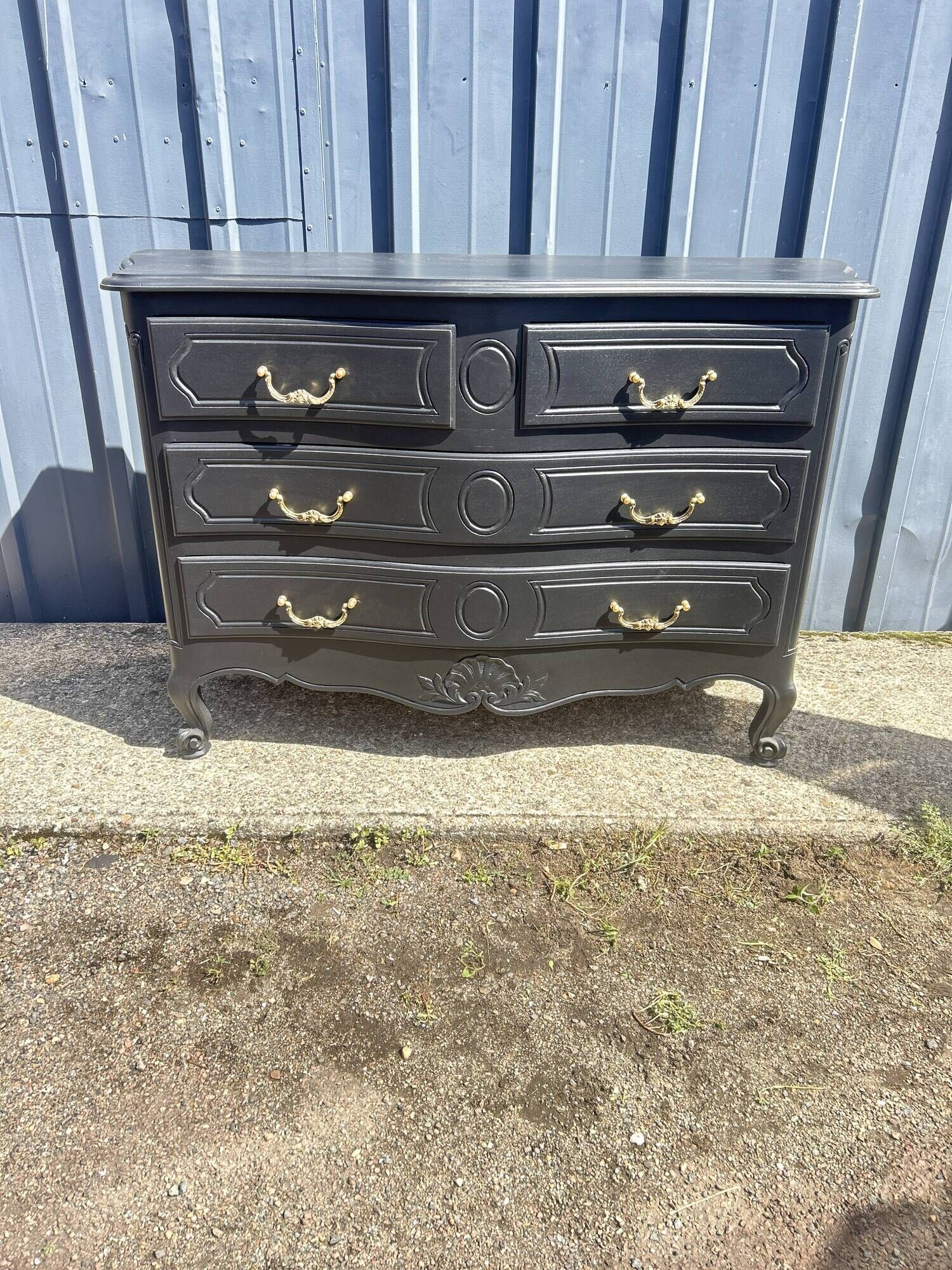 Louis XV style black lacquered chest of drawers with four drawers.