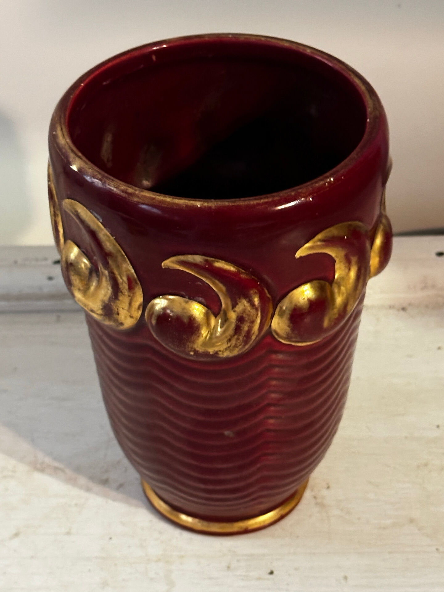 Mid-century relief vase in ruby red enhanced with gilding.