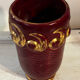 Mid-century relief vase in ruby red enhanced with gilding.