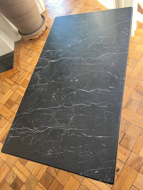 Black marble coffee table with brass legs.