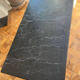 Black marble coffee table with brass legs.