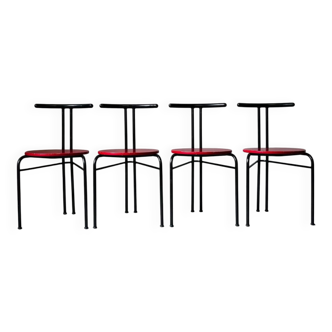 Set of 4 vintage black metal chairs with red lacquered seats.
