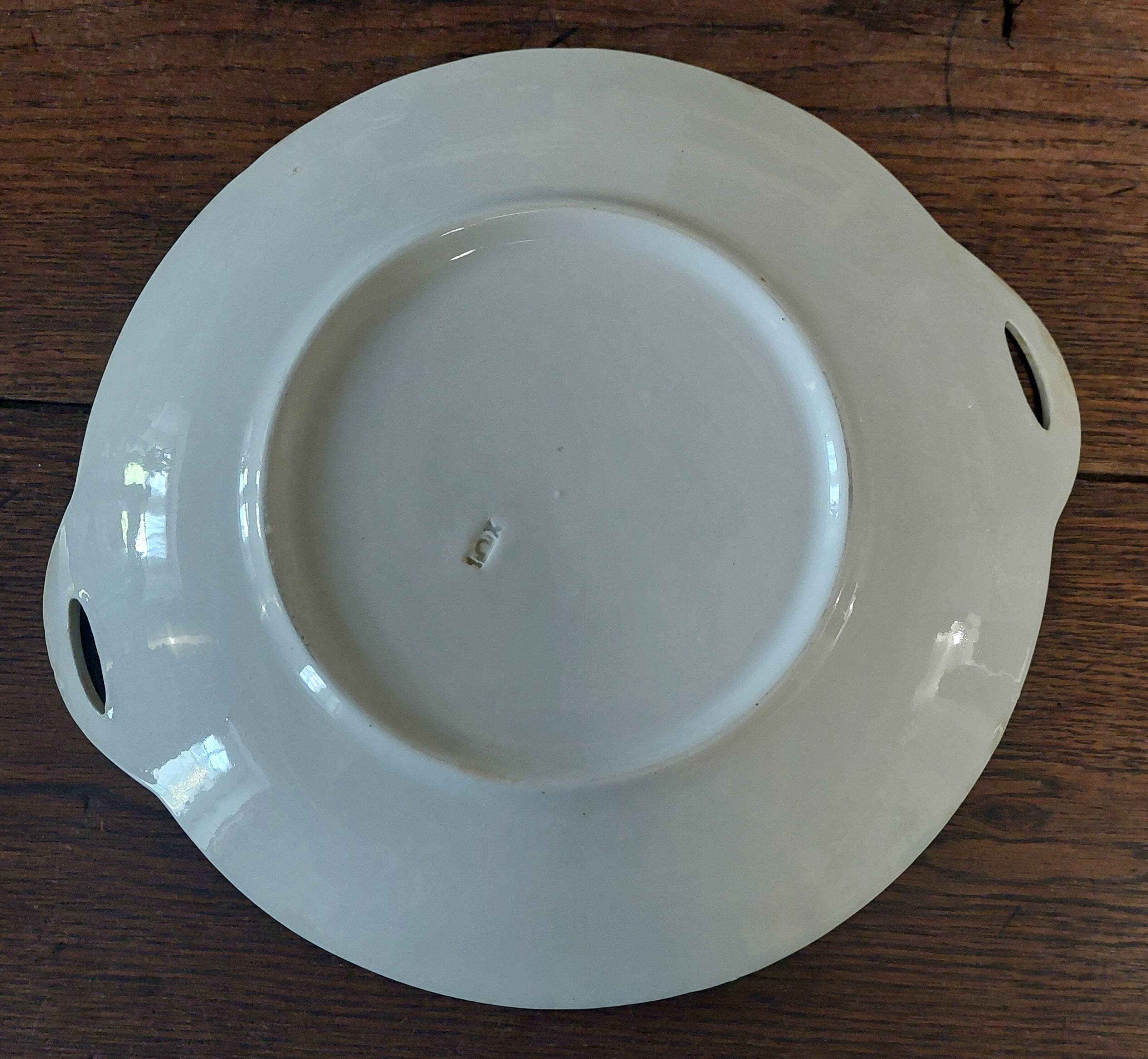 Round serving dish in iron earthenware, first half of the 20th century