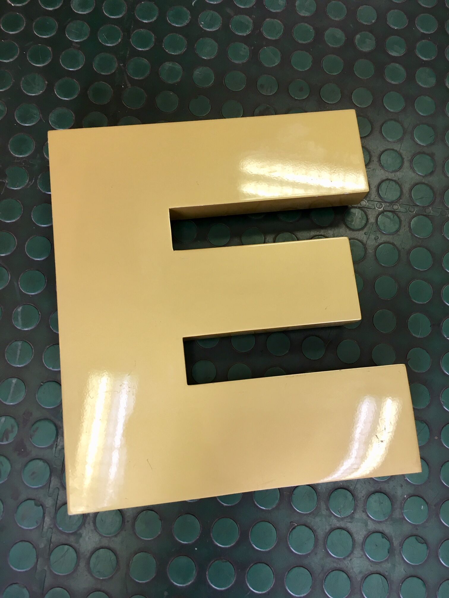Golden sign letter E