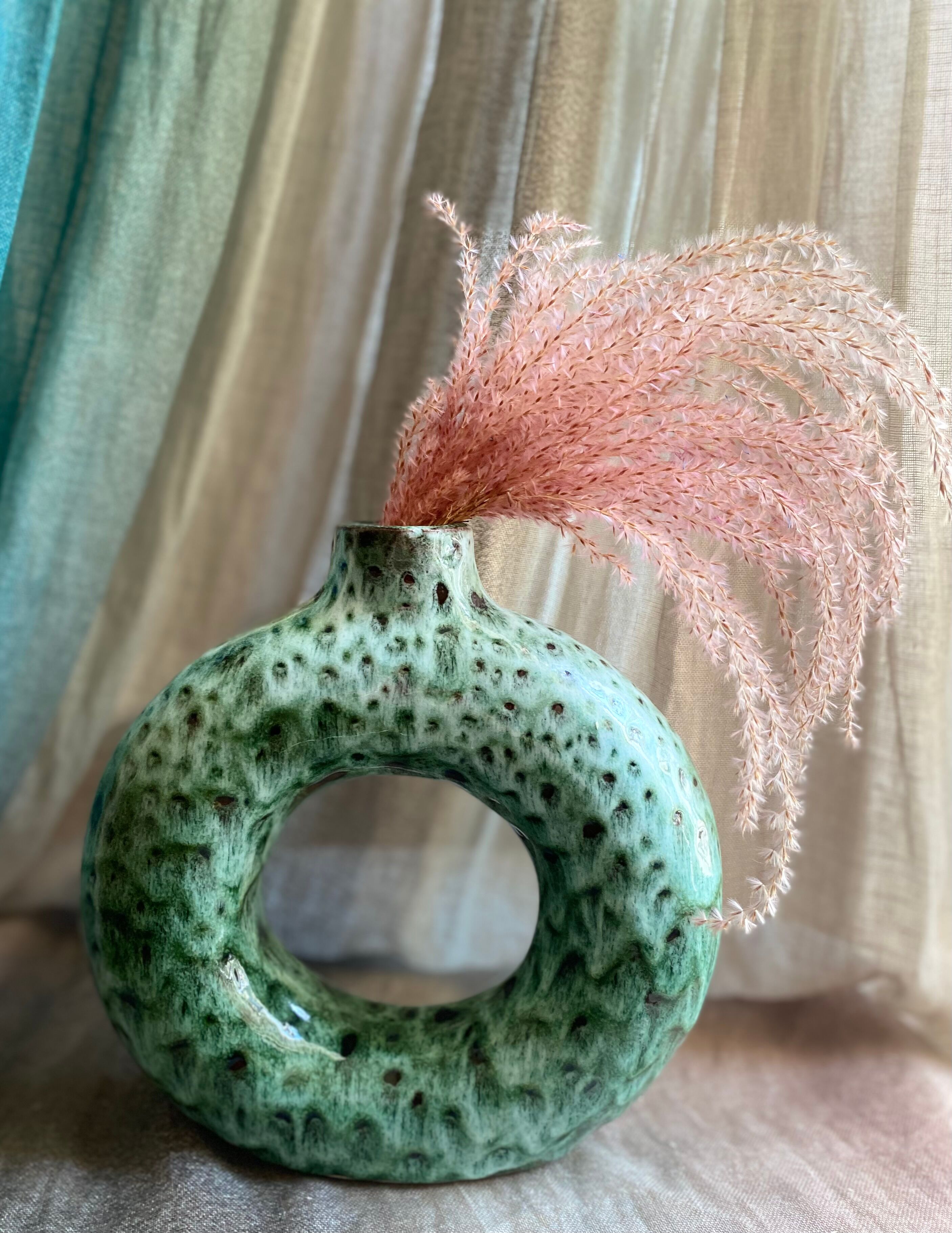 Handmade terracotta donut vase in light green terracotta