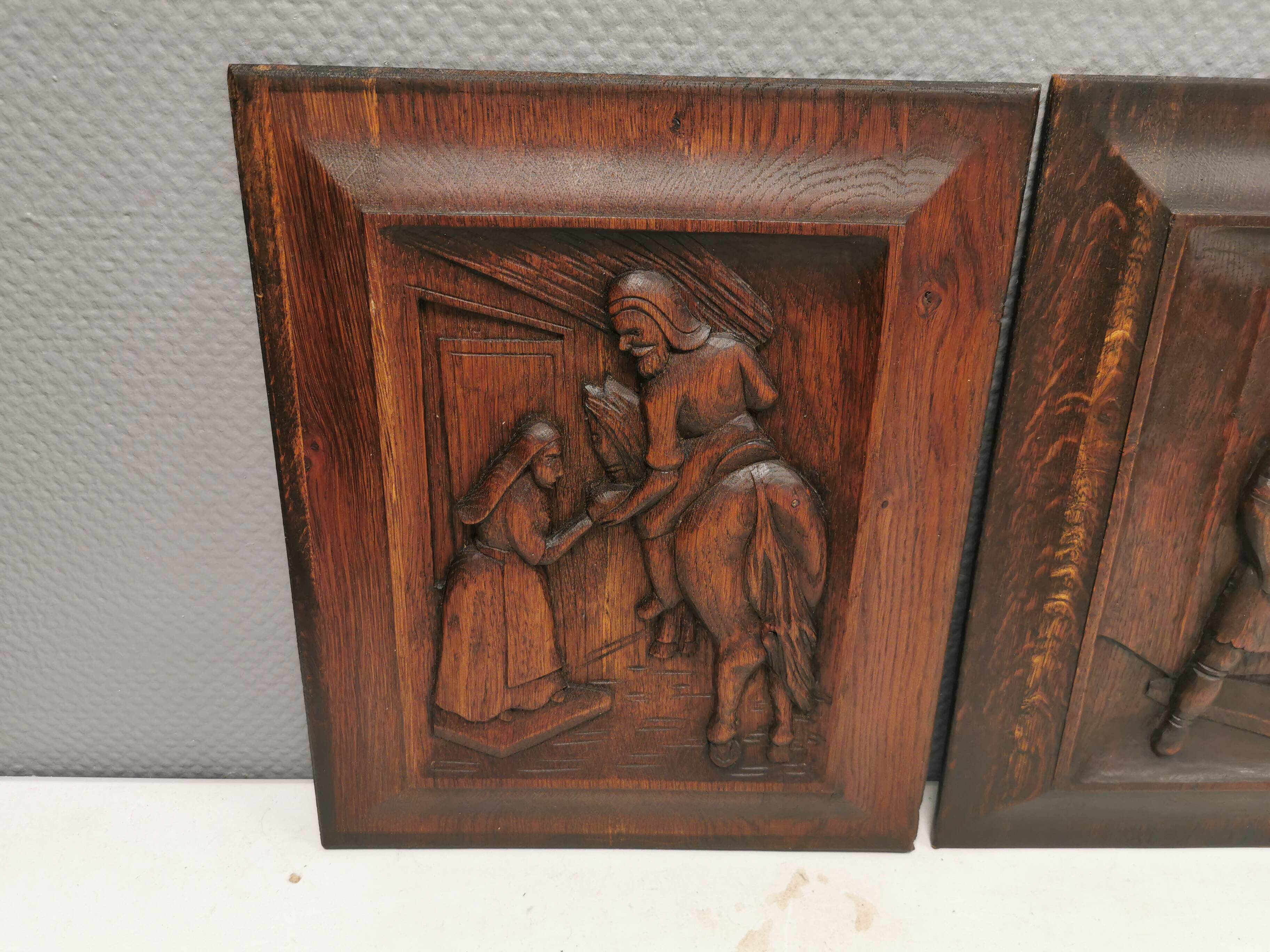 Four old wooden carvings to hang on the wall.
