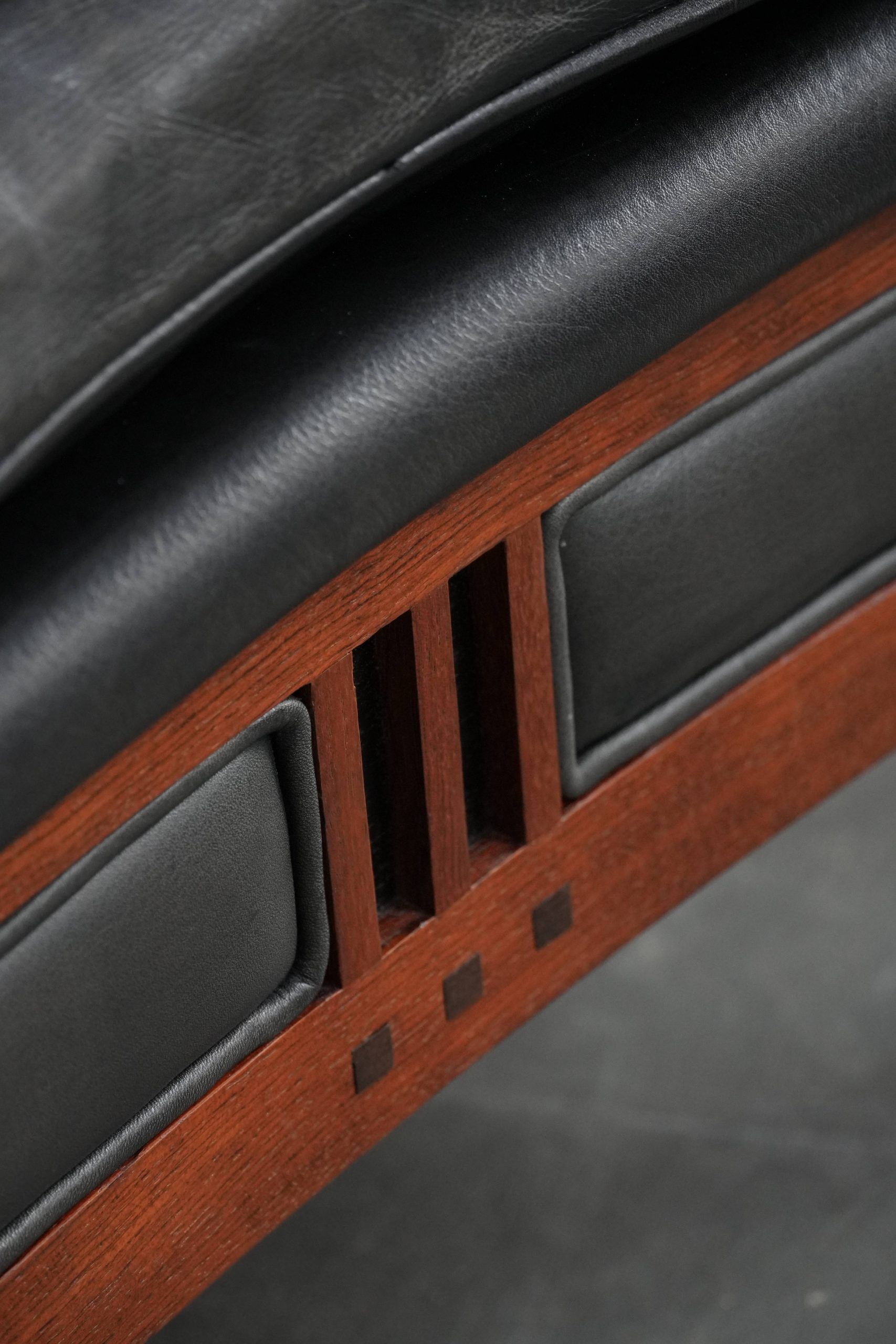 Black cowhide leather and wooden Art Deco design armchair