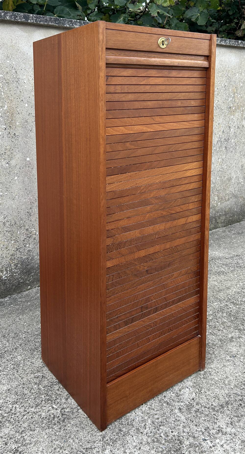 Vintage wooden filing cabinet with curtains.