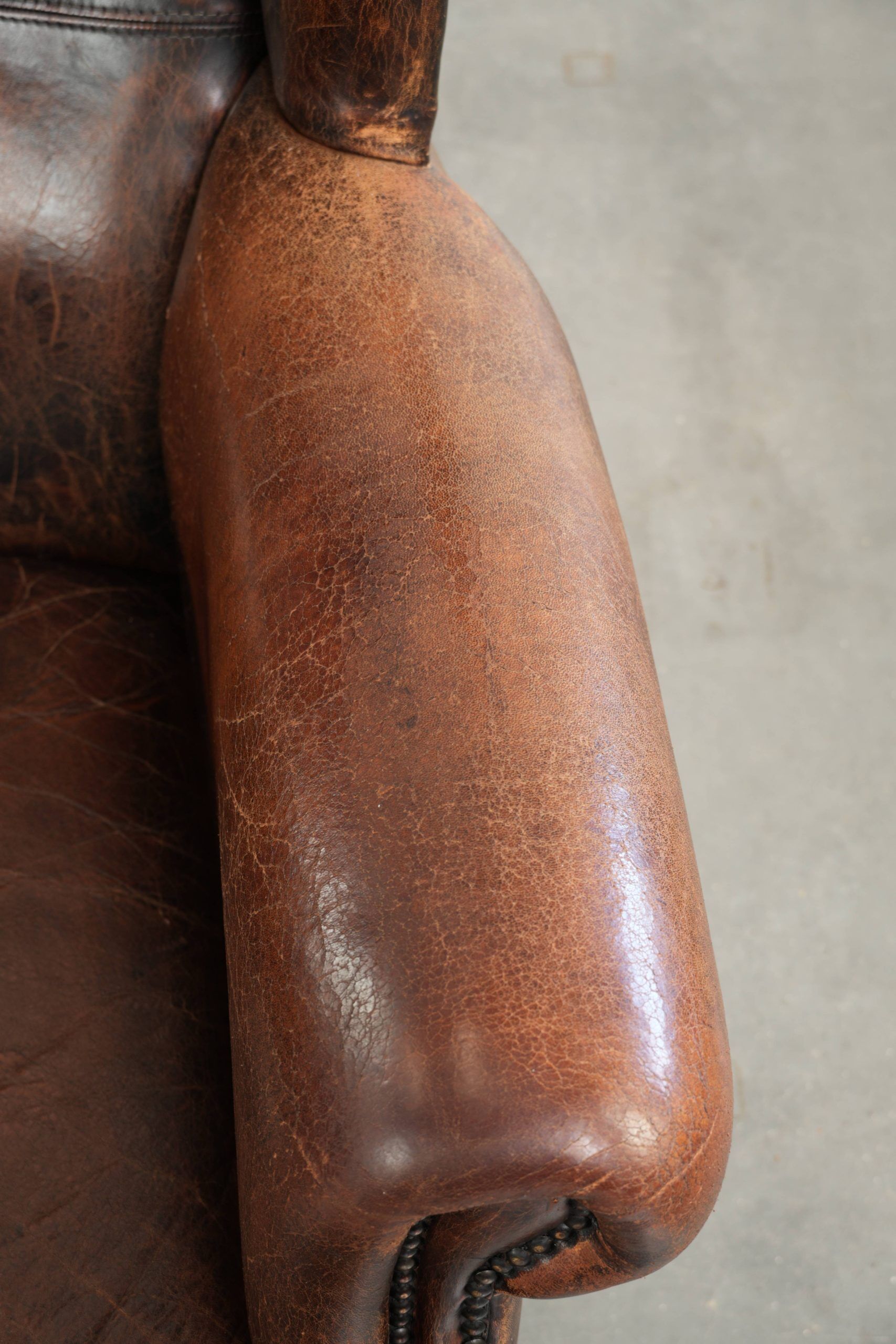 Vintage sheepskin wingback armchair in a deep brown colour finished