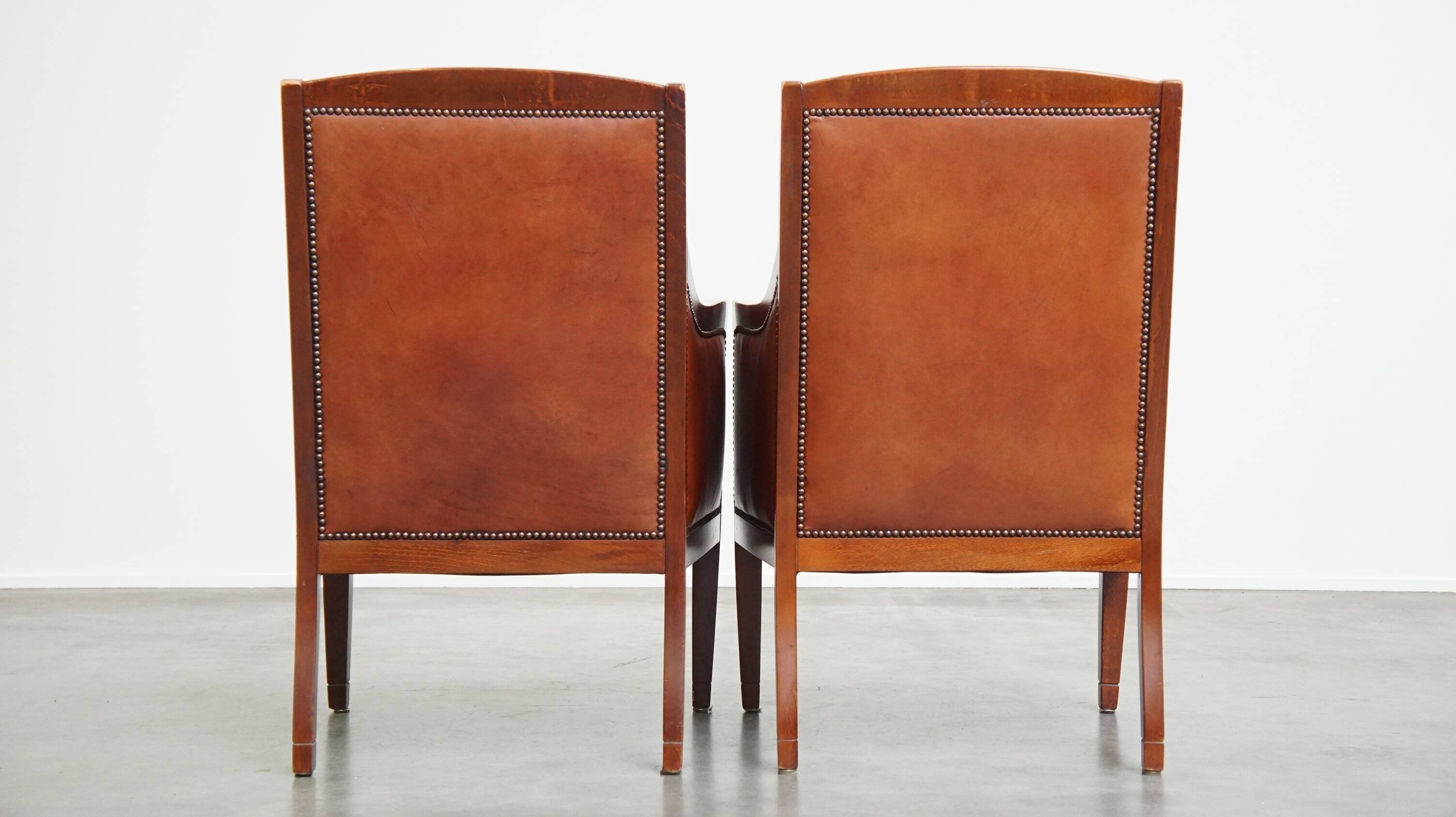 Set of 2 cognac-colored cowhide Art Deco design armchairs