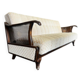 Vintage wooden armchair with rattan weaving.