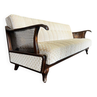 Vintage wooden armchair with rattan weaving.