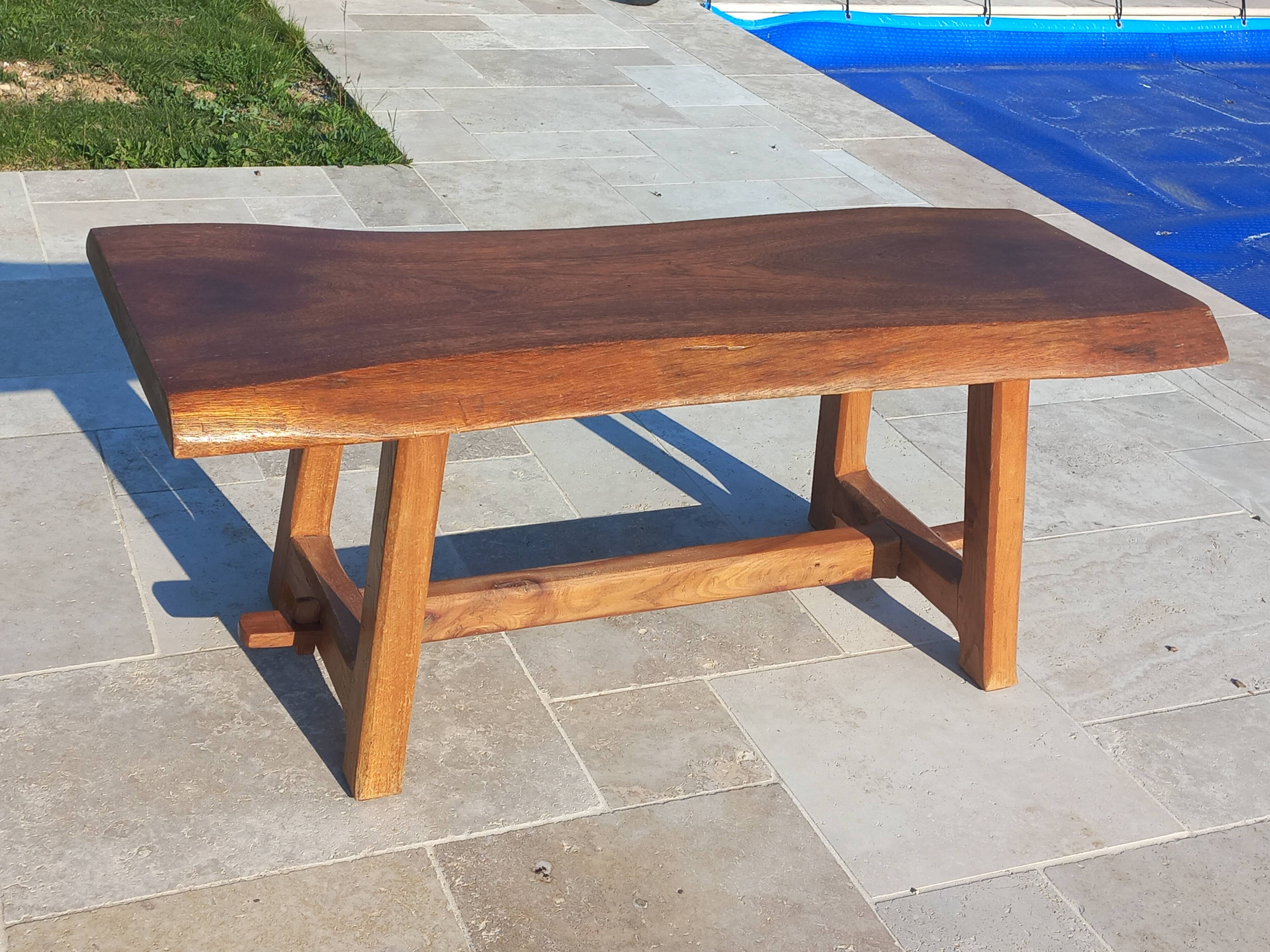 Rustic handcrafted coffee table with a mahogany top and elm legs.