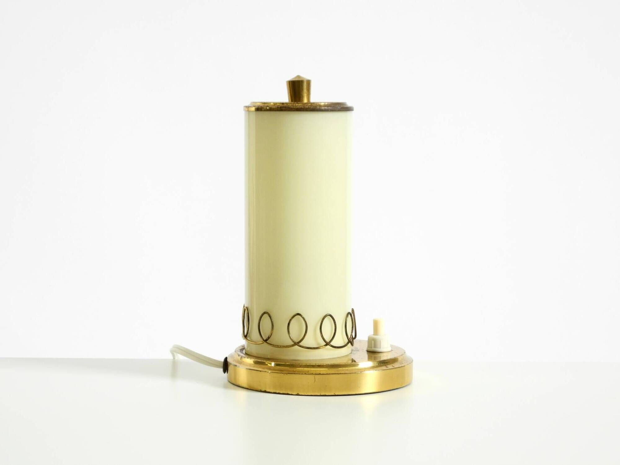 A beautiful, rare 1950s brass table lamp with one opal glass shade adorned